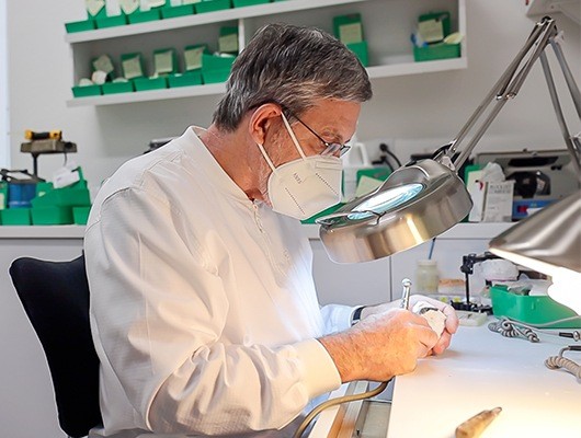 Dentist working in lab with mask on