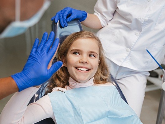 girl giving dentist a high five