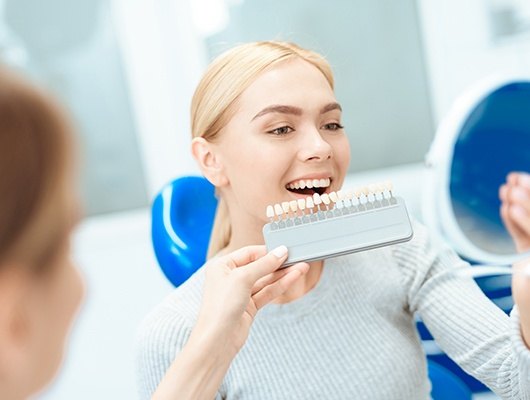 veneer chart in front of woman smiling