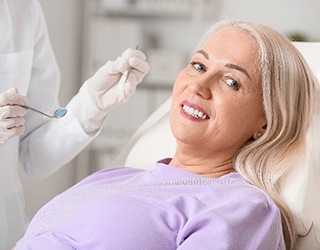 a patient receiving her new dentures in Coral Springs