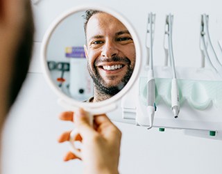 a man smiling after receiving his dentures in Coral Springs