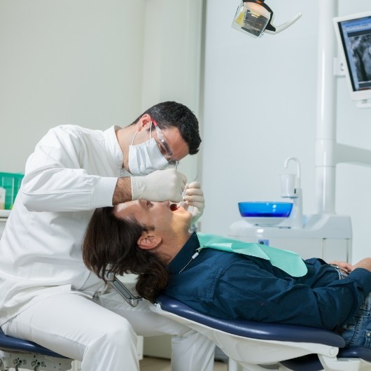 Dentist working on male patient