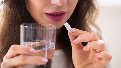 Woman taking a pill