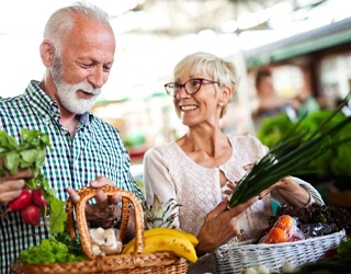 elderly couple shopping for fruits and vegetables