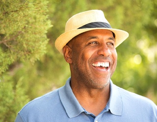 man in a blue polo shirt standing in a forest