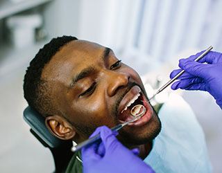 a dentist examining a patient’s smile
