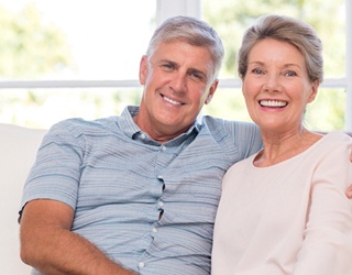 Older couple with dental implants in Coral Springs smiling