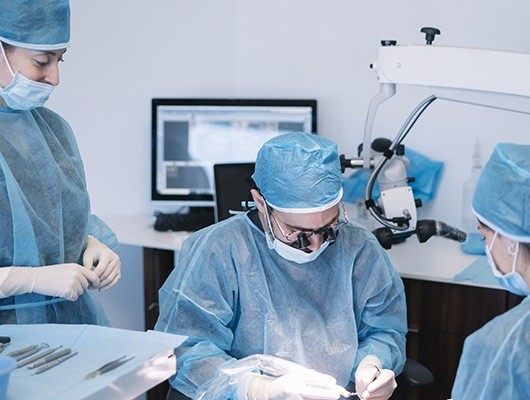 three team members working on patient