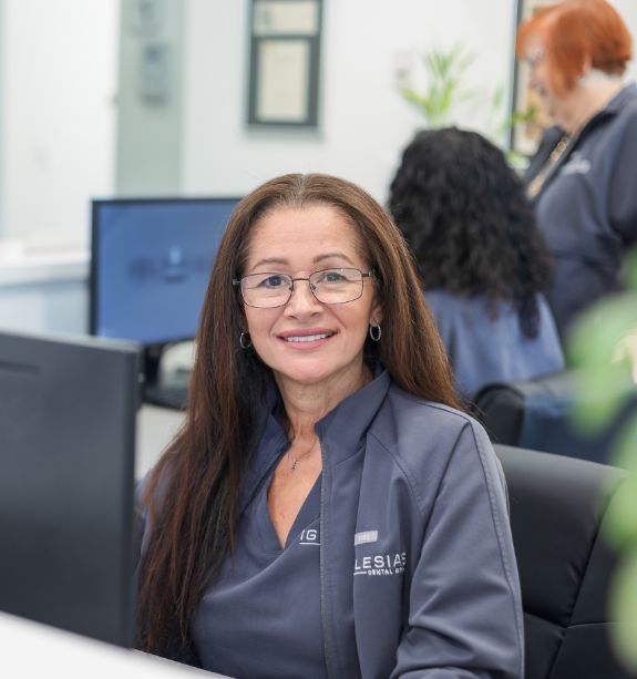 Iglesias Dental Group team member smiling at the front desk