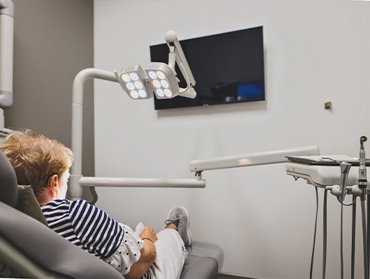 woman laying back in exam chair