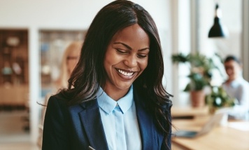 woman in business attire smiling