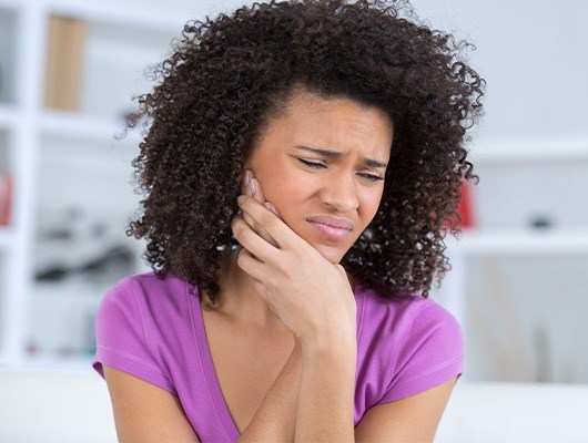 woman with curly hair in pain