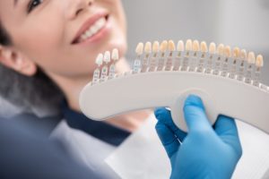 Dentist holding veneers