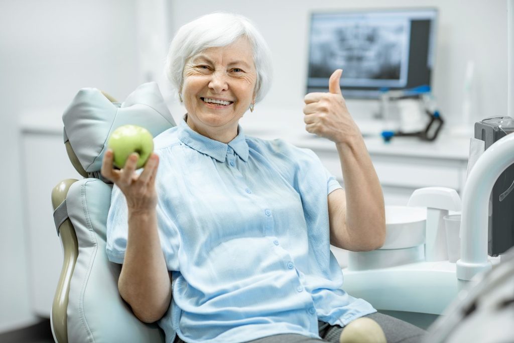 A woman holding an apple