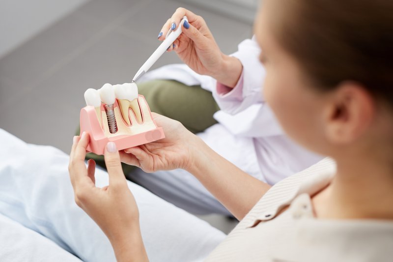 dentist explaining dental implant surgery to patient