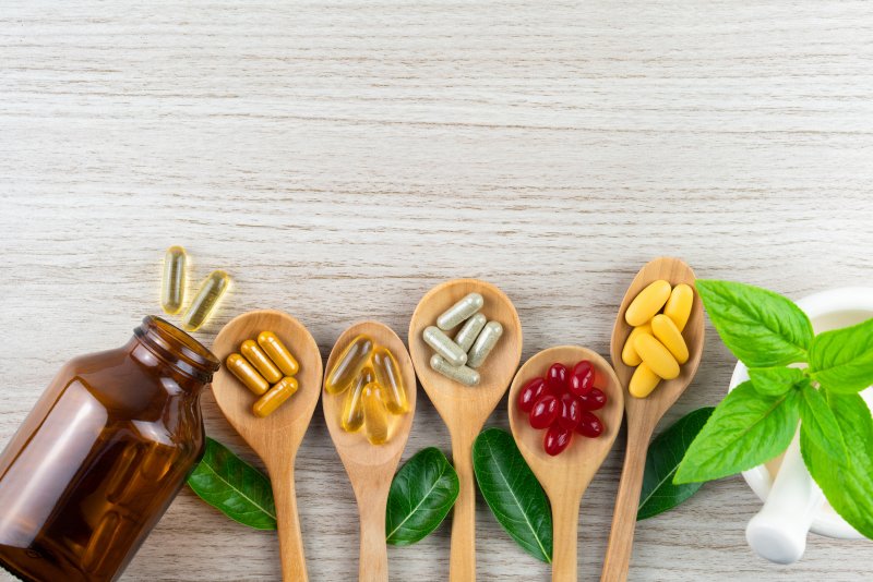 Vitamin and mineral supplements placed on wooden spoons