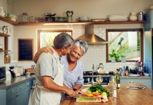 mature couple making dinner