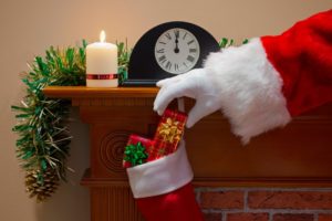 Santa putting in stocking stuffers