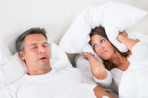 woman angry as husband snores loudly