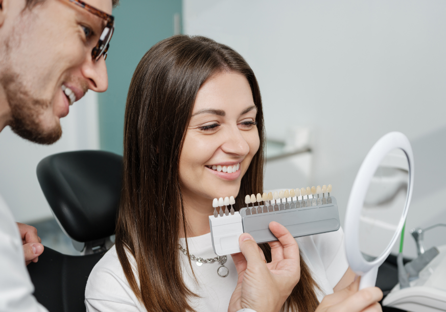 Dentist showing woman veneer shades